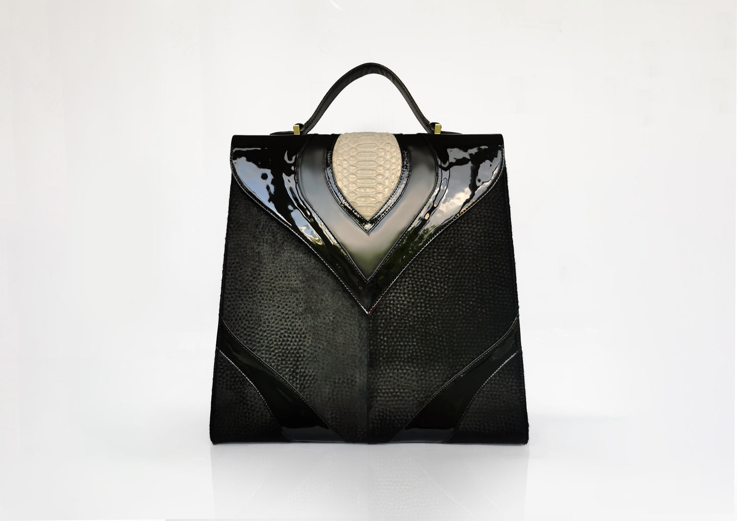 Elegant black handbag with python skin and pony leather details, handmade in Bucharest, Romania.