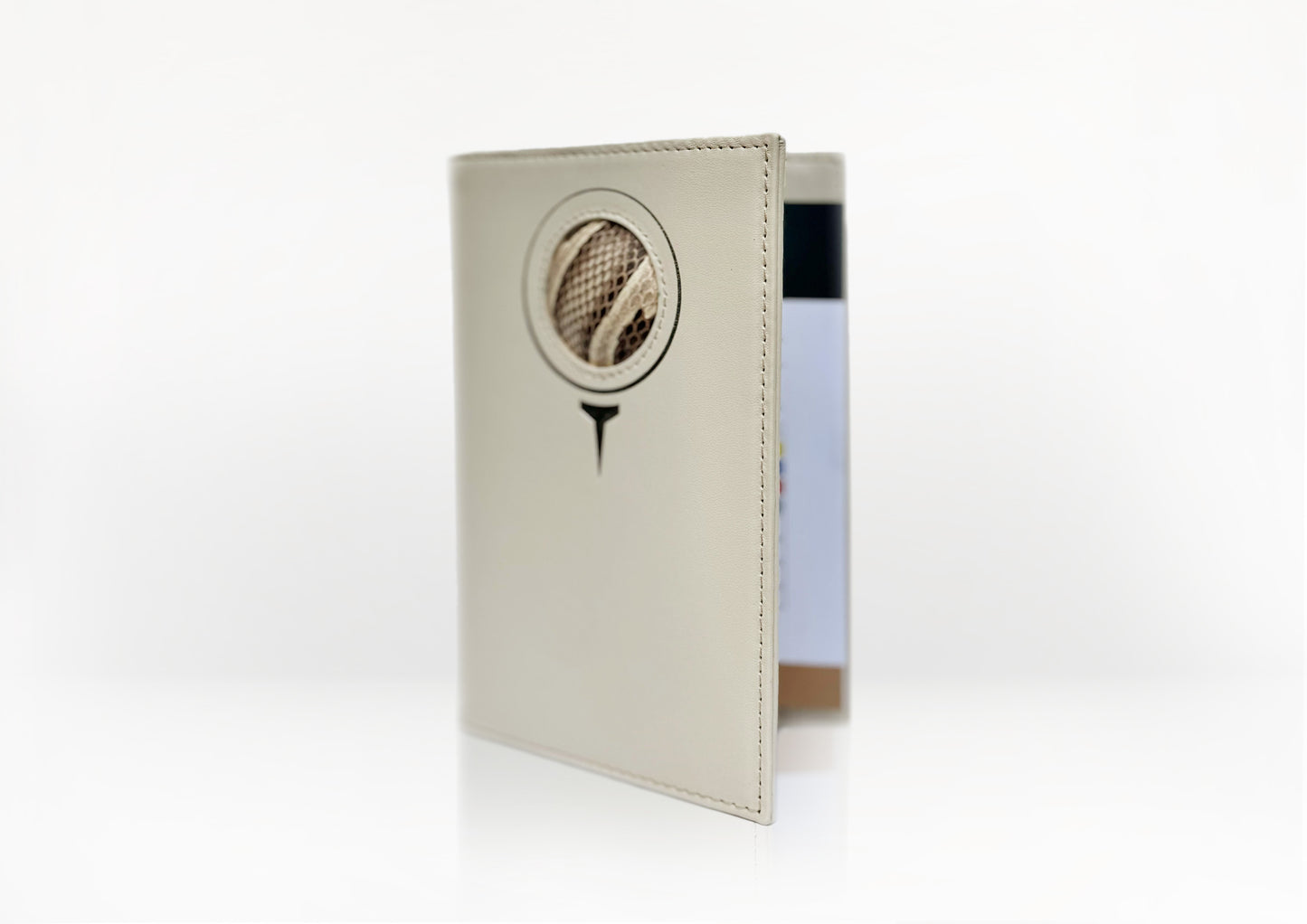 Angled view of the Carte du Jeu golf scorecard holder – handcrafted in matte light beige calfskin with natural python insert and refined stitching.