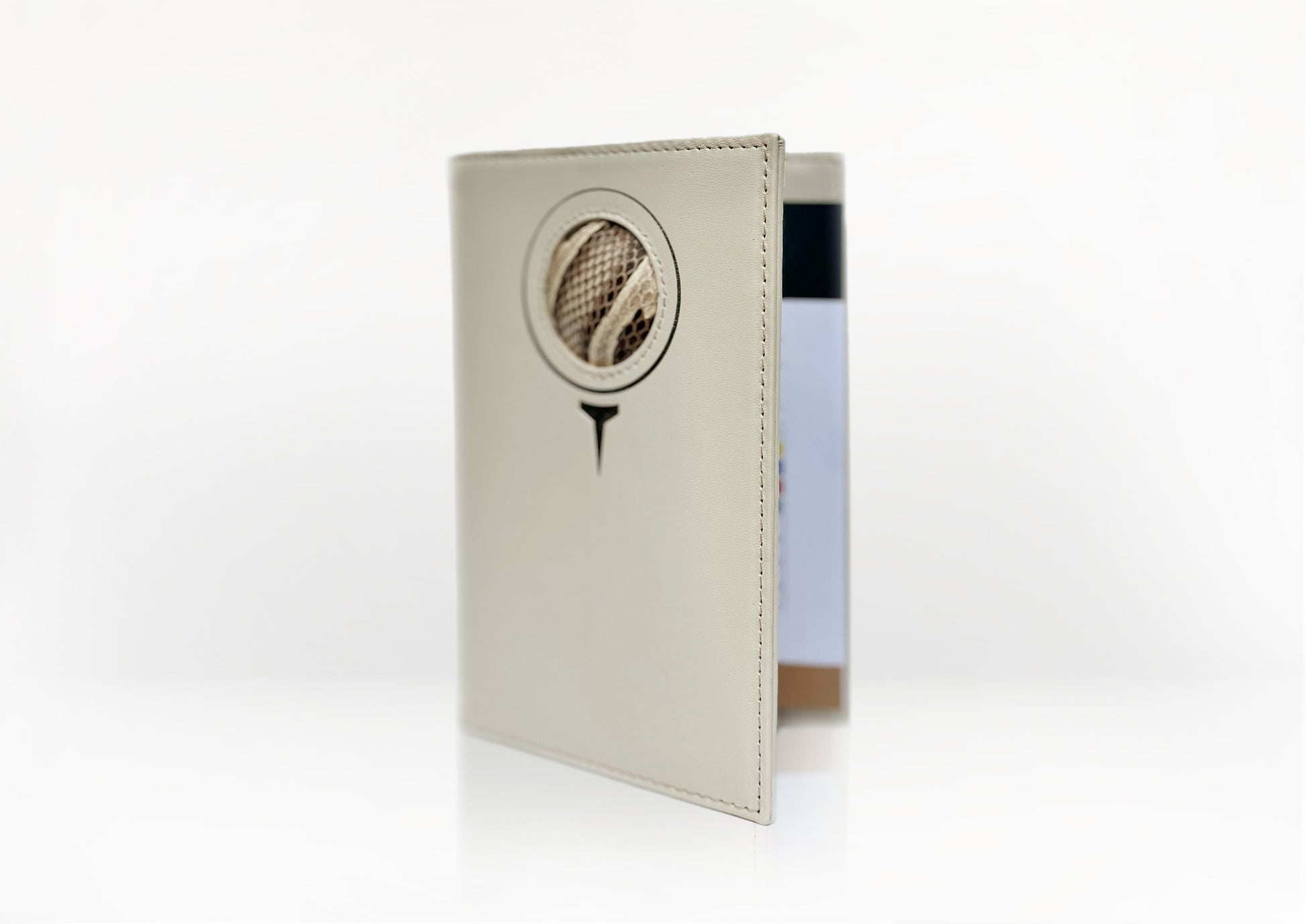 Angled view of the Carte du Jeu golf scorecard holder – handcrafted in matte light beige calfskin with natural python insert and refined stitching.