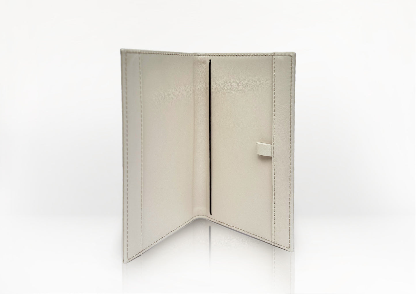 Carte du Jeu luxury golf scorecard holder opened flat, showing smooth beige calf leather and internal structure for organizing scorecards.