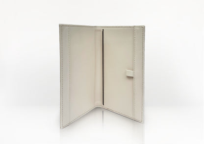 Carte du Jeu luxury golf scorecard holder opened flat, showing smooth beige calf leather and internal structure for organizing scorecards.