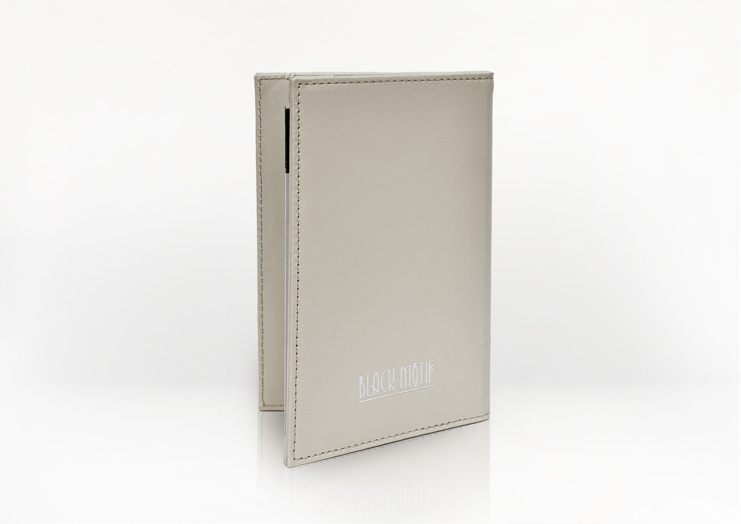Side profile of the Carte du Jeu scorecard holder in matte light beige calfskin, showcasing fine stitching and slim handcrafted design.