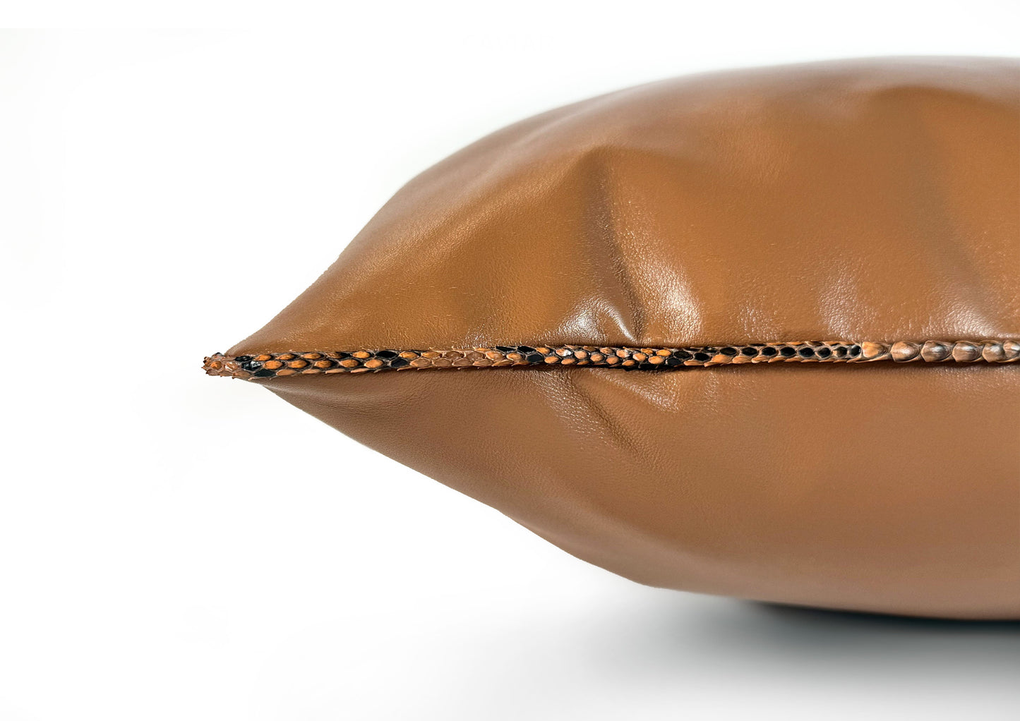 Detail of the Sahara Python piping that frames the Dune Large luxury cushion.