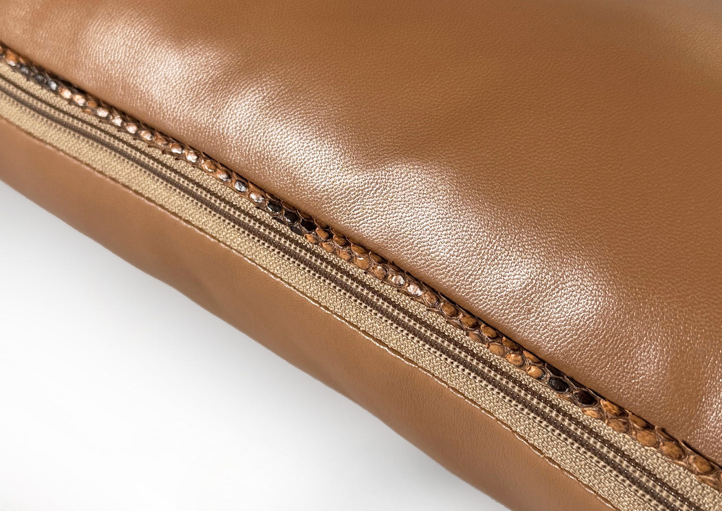 Close-up of the Mocha zipper detail on the Dune Small cushion, crafted from Golden Sand goat leather and Sahara Python.