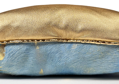 Close-up of the gold sheepskin, blue calf leather with gold patina, and pink hair-on-hide from the Fleurie cushion.