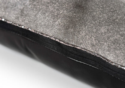 Close-up of the black zipper on the Metropolitan Large Square cushion, crafted from grey hair-on-hide and black calf leather.