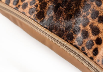 Hidden zipper detail of the Savannah II luxury cushion, crafted from hair-on-hide calf and caramel goat leather.