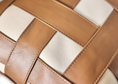 Close-up of the handwoven Terracotta Tan and Soft Ivory leather weave on the Terracotta Weave Large cushion.
