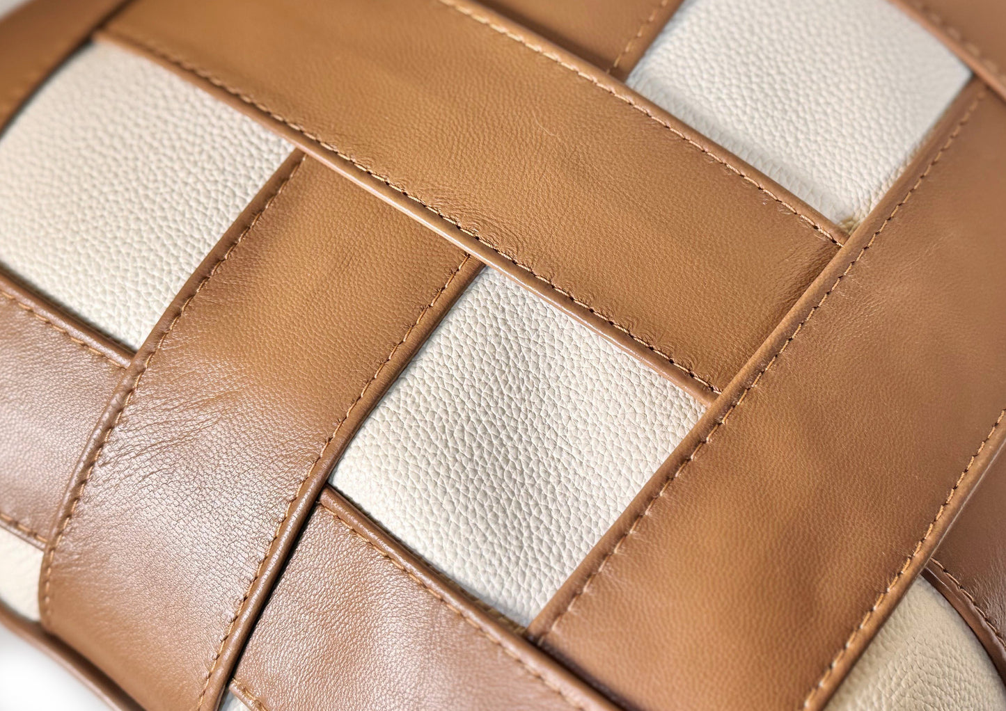 Close-up of the handwoven Terracotta Tan and Soft Ivory leather weave on the Terracotta Weave Small cushion.