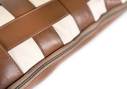Close-up of the hidden zipper on the Terracotta Weave Small cushion, crafted from caramel and ivory leather.